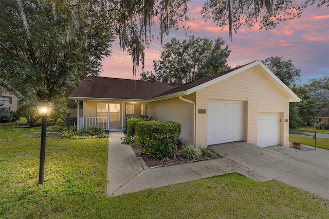 ranch-style home with a porch, central AC, a garage, and a lawn