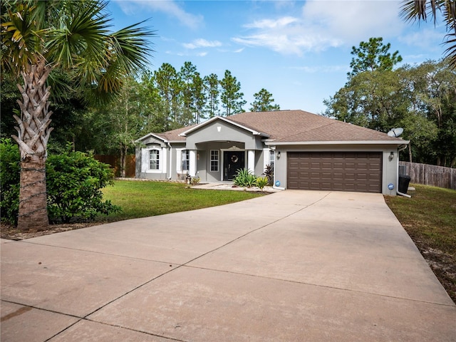 ranch-style house featuring a front yard and a garage