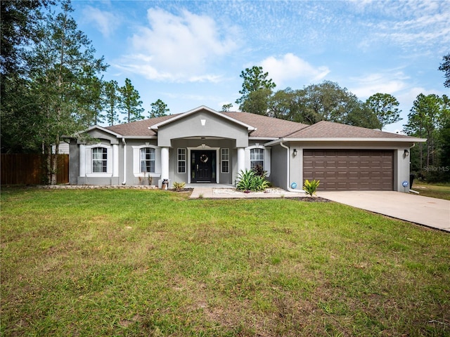 ranch-style house featuring a garage and a front yard