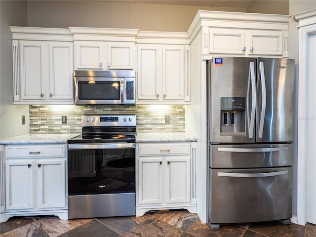 kitchen with white cabinetry, backsplash, stainless steel appliances, and light stone countertops