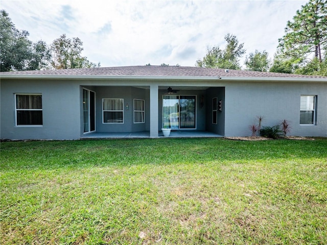 back of house with a lawn, ceiling fan, and a patio area