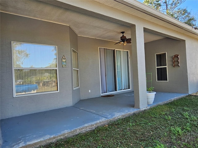 property entrance with ceiling fan and a patio