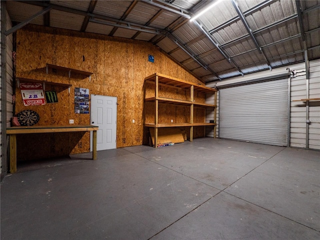 garage with a workshop area and wood walls