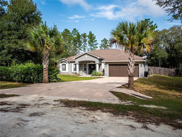 view of front of home with a garage and a front yard