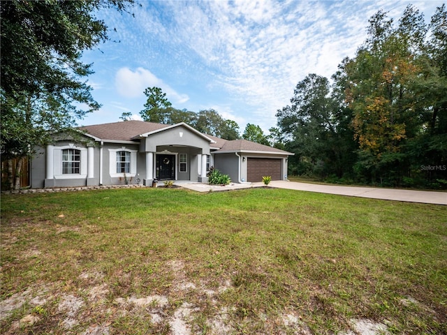 ranch-style house featuring a garage and a front lawn