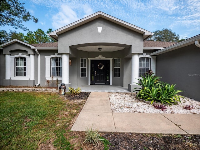 12805 SW 64th Ln, Ocala, FL 34481 - entrance to property with stucco siding, covered porch, and a shingled roof