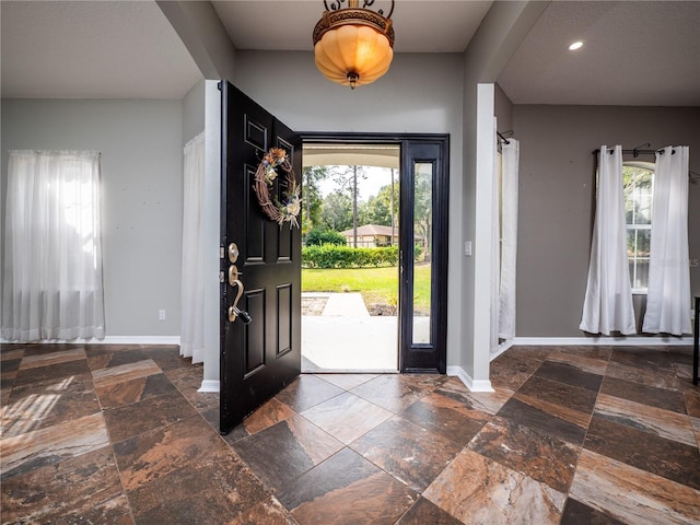 12805 SW 64th Ln, Ocala, FL 34481 - foyer entrance with stone tile floors, baseboards, and recessed lighting