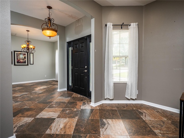 12805 SW 64th Ln, Ocala, FL 34481 - entrance foyer featuring stone tile floors, baseboards, and a chandelier