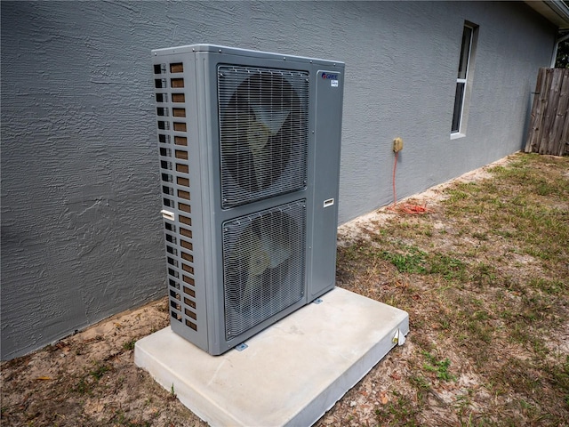 12805 SW 64th Ln, Ocala, FL 34481 - exterior view of stucco siding, a cooling unit, and fence