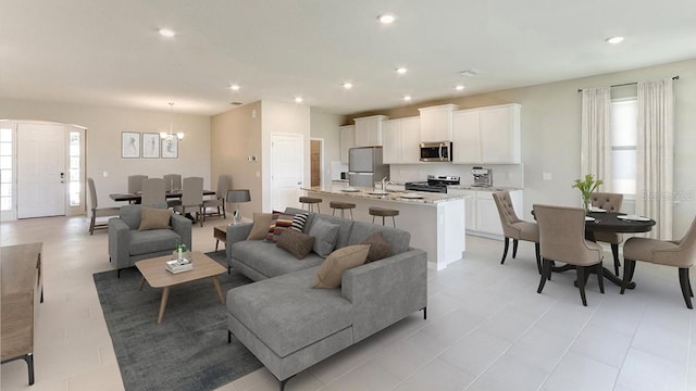 living room featuring a chandelier, a healthy amount of sunlight, and light tile patterned floors