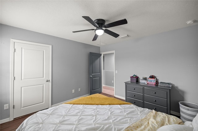 bedroom with a textured ceiling and ceiling fan