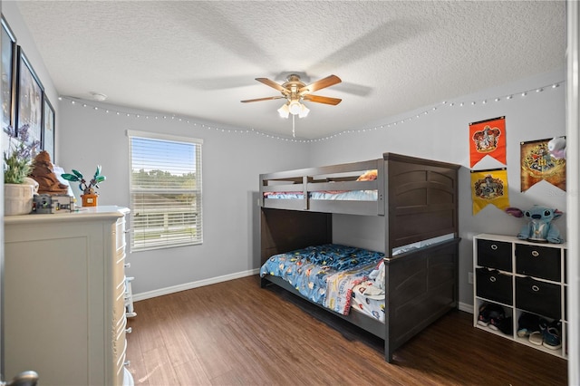 bedroom featuring ceiling fan, a textured ceiling, and dark hardwood / wood-style flooring