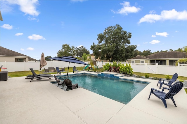 view of swimming pool featuring a patio area and a lawn