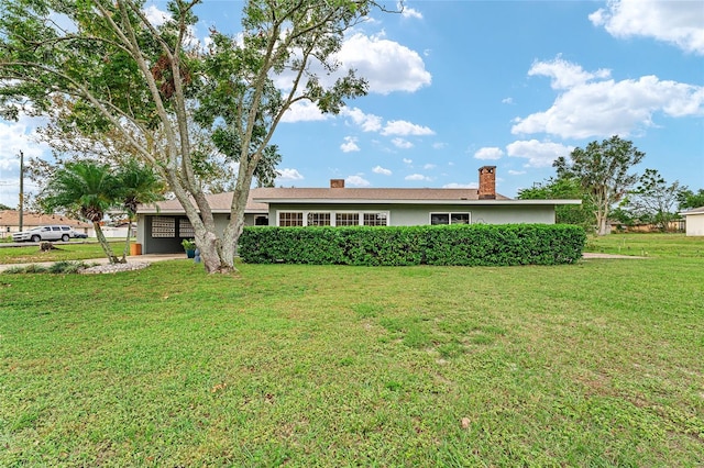 ranch-style home featuring a front yard and a garage