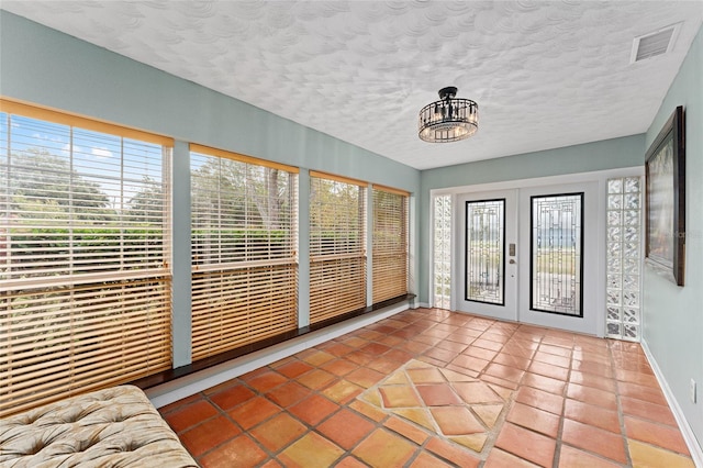 unfurnished sunroom with french doors