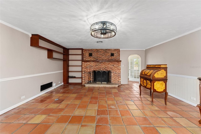 unfurnished living room with crown molding, a textured ceiling, a fireplace, and tile patterned flooring