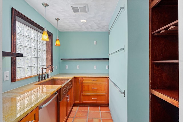 kitchen with light tile patterned flooring, dishwasher, sink, and pendant lighting