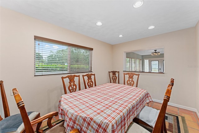 dining space with light tile patterned flooring and plenty of natural light