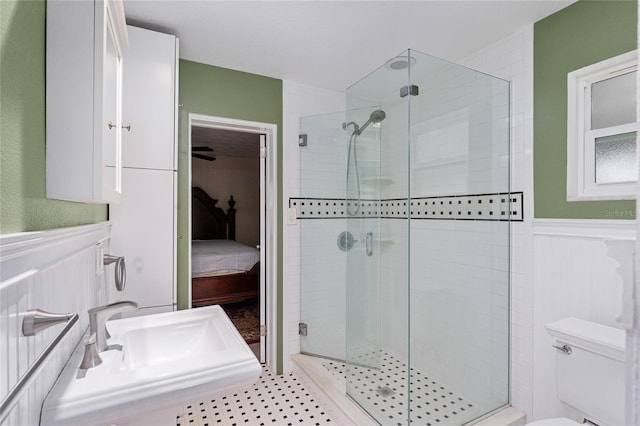 bathroom featuring toilet, an enclosed shower, and sink