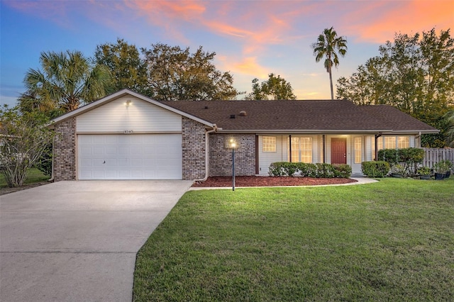 ranch-style house with a lawn and a garage