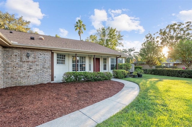 ranch-style house featuring a front lawn