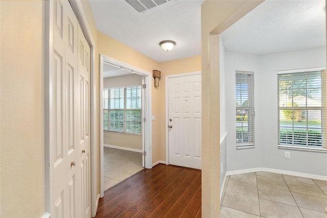 entryway featuring hardwood / wood-style floors and a textured ceiling