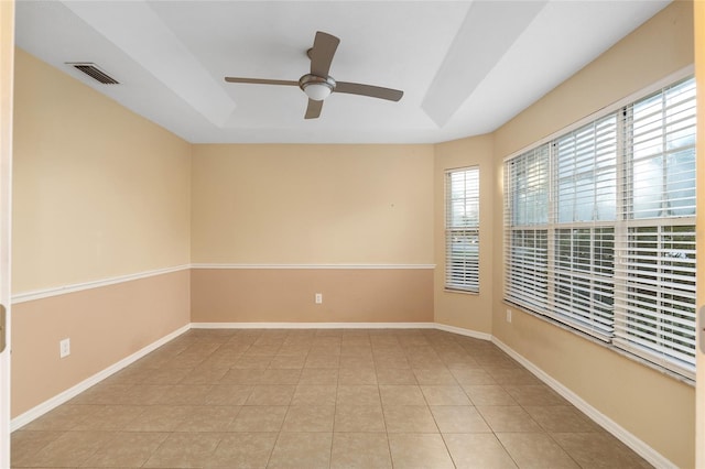 spare room featuring ceiling fan and light tile patterned floors