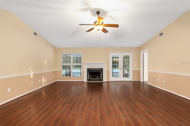 unfurnished living room featuring french doors, dark hardwood / wood-style floors, and a wealth of natural light