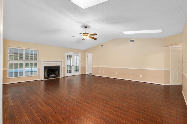 unfurnished living room featuring dark wood-type flooring, a healthy amount of sunlight, and french doors