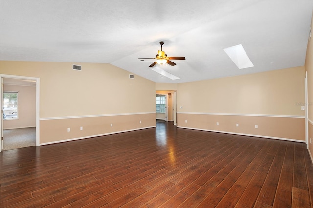 empty room with ceiling fan, dark wood-type flooring, and vaulted ceiling