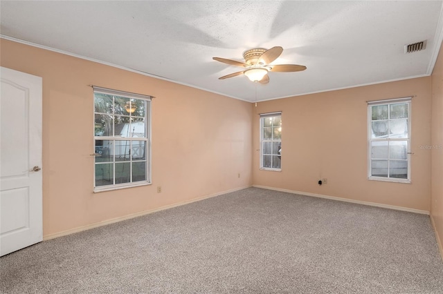 spare room with ceiling fan, carpet flooring, and plenty of natural light