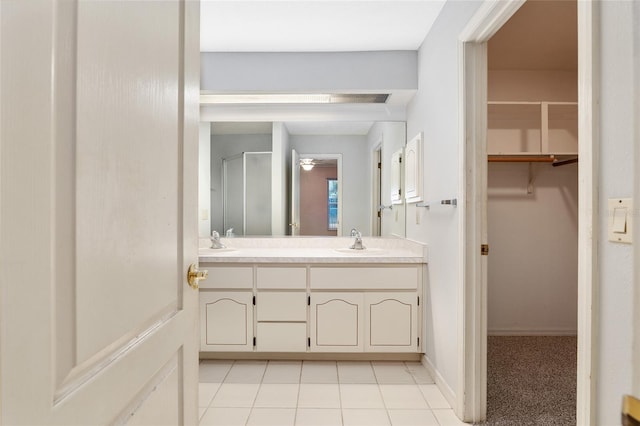 bathroom featuring vanity, an enclosed shower, and tile patterned flooring