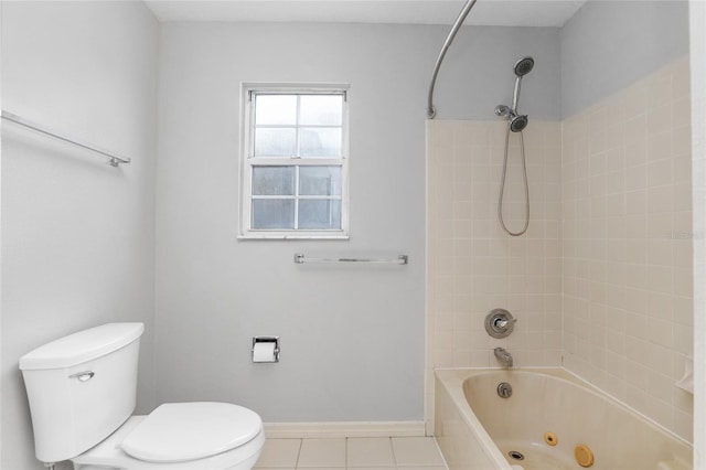 bathroom with toilet, tiled shower / bath, and tile patterned flooring