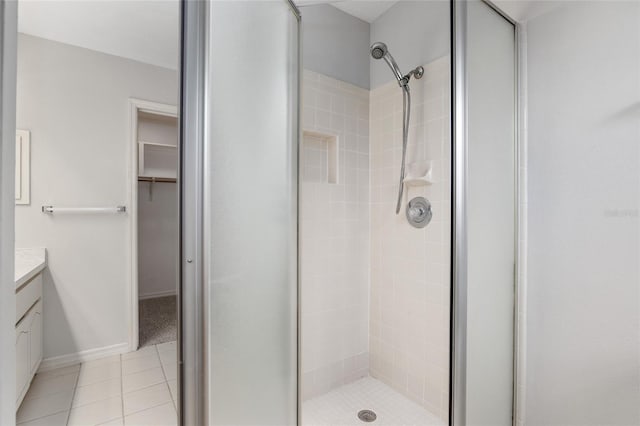 bathroom with vanity, walk in shower, and tile patterned flooring