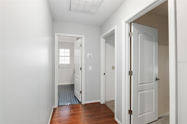 corridor with dark hardwood / wood-style flooring