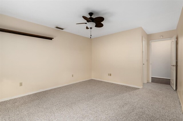 carpeted empty room featuring ceiling fan