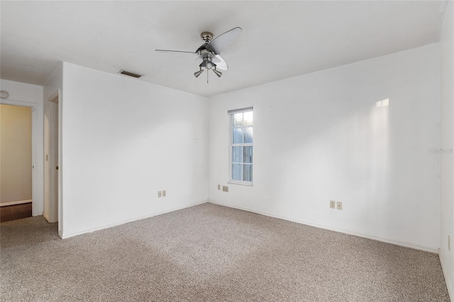 carpeted spare room featuring ceiling fan