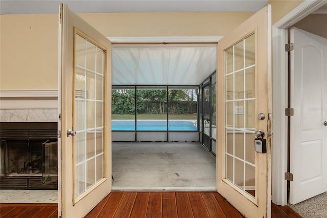 unfurnished sunroom featuring a high end fireplace