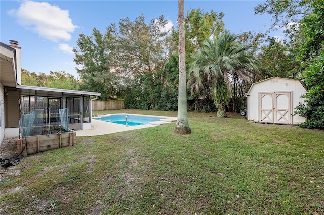 view of yard with a storage unit, a fenced in pool, and a sunroom