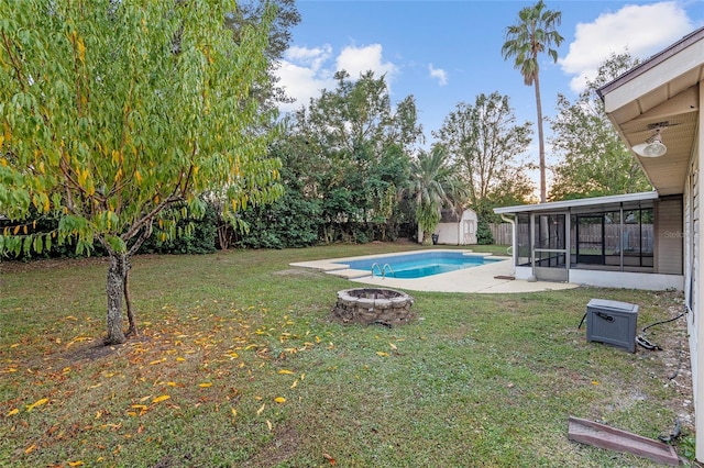 view of yard with a sunroom and an outdoor fire pit