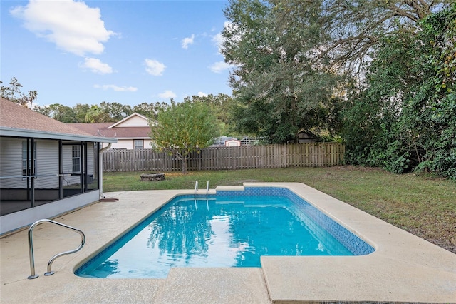 view of pool with a yard, a patio, and a sunroom