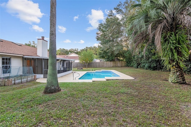 view of pool featuring a patio, a yard, and a sunroom