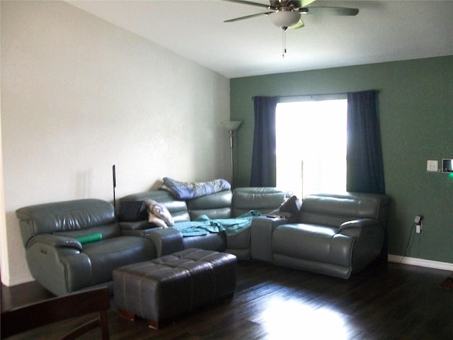 living room featuring lofted ceiling, dark wood-type flooring, and ceiling fan