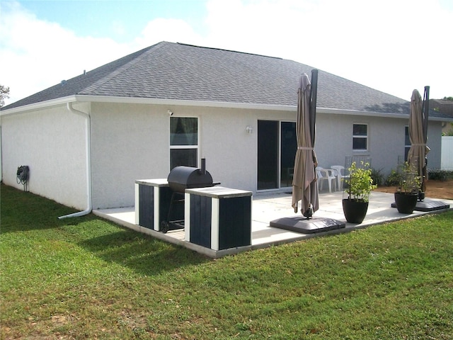 rear view of house with a patio area and a yard