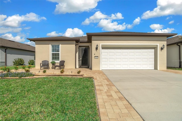 view of front of house with a front yard and a garage