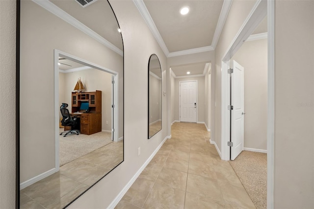 hall featuring ornamental molding and light colored carpet