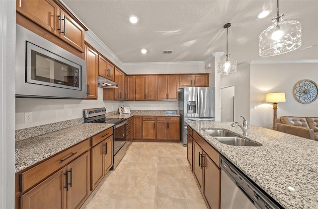 kitchen with stainless steel appliances, ornamental molding, sink, pendant lighting, and light stone counters