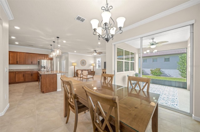 tiled dining area featuring crown molding, a wealth of natural light, and ceiling fan with notable chandelier