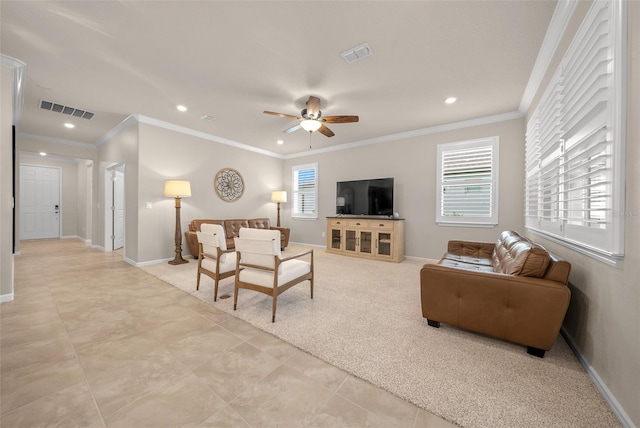 living room with light carpet, ornamental molding, and ceiling fan