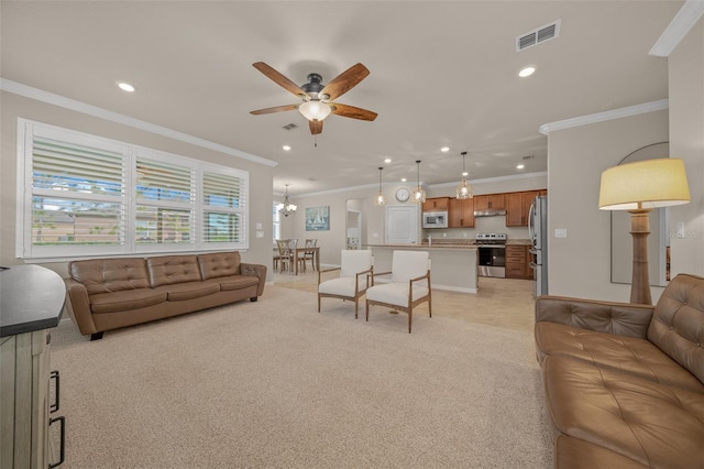 carpeted living room with crown molding and ceiling fan with notable chandelier